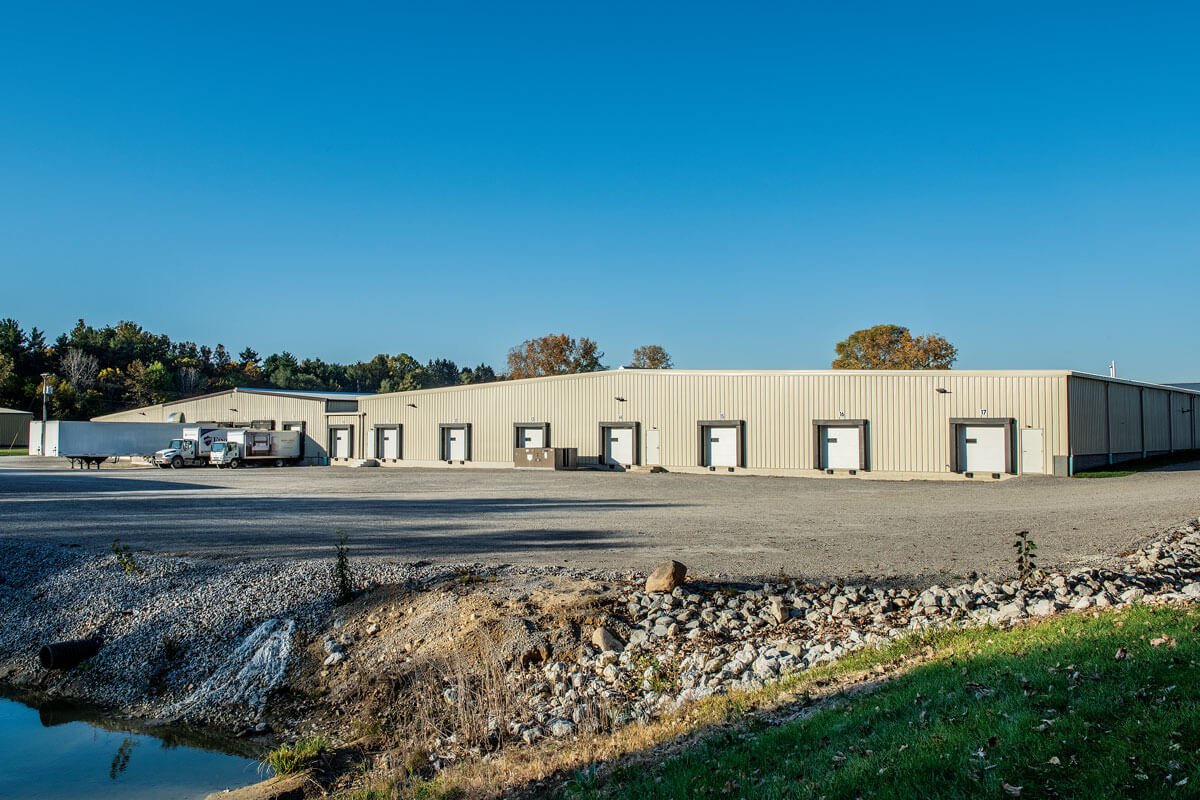 Spectrum Finishing PCL Facility Loading Docks with Delivery Trucks